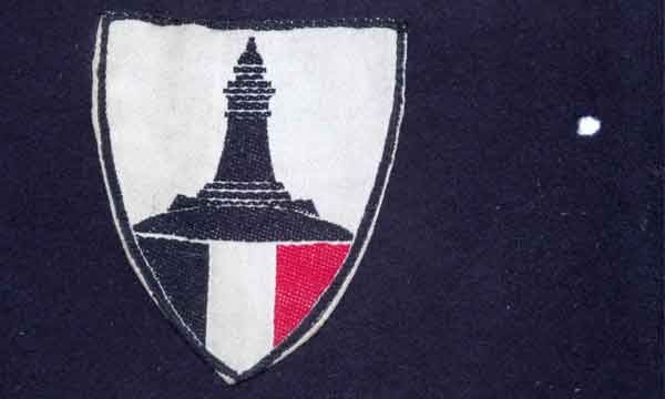 4 mm moth hole to the right of shield 